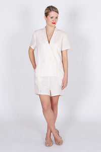 Woman wearing the Diana Playsuit sewing pattern by I AM Patterns. A playsuit pattern made in crepe, Tencel, linen, chambray, cotton, viscose twill or lightweight denim fabrics, featuring short sleeves, shawl collar, in-seam pockets and front button closur