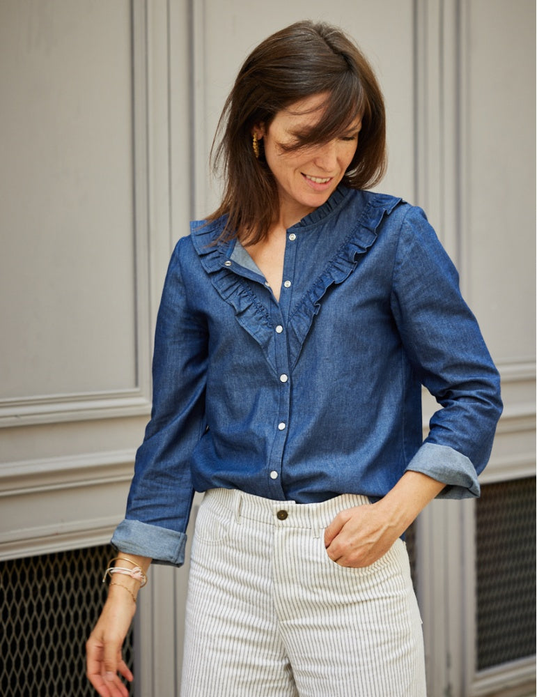 Women wearing the Diapason Blouse sewing pattern from Atelier Scämmit on The Fold Line. A blouse pattern made in lightweight woven batiste, poplin or serge fabrics, featuring a round neck, gathered flounce, button placket, diagonal gathered front flounce,