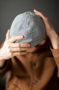 Woman wearing the Docker's Beanie sewing pattern from Merchant & Mills on The Fold Line. A Beanie Hat pattern made in oilskin, dry oilskin, mid weight cotton canvas or drill, corduroy, and mid weight denim fabrics, featuring six-panels, beanie, turned-up 