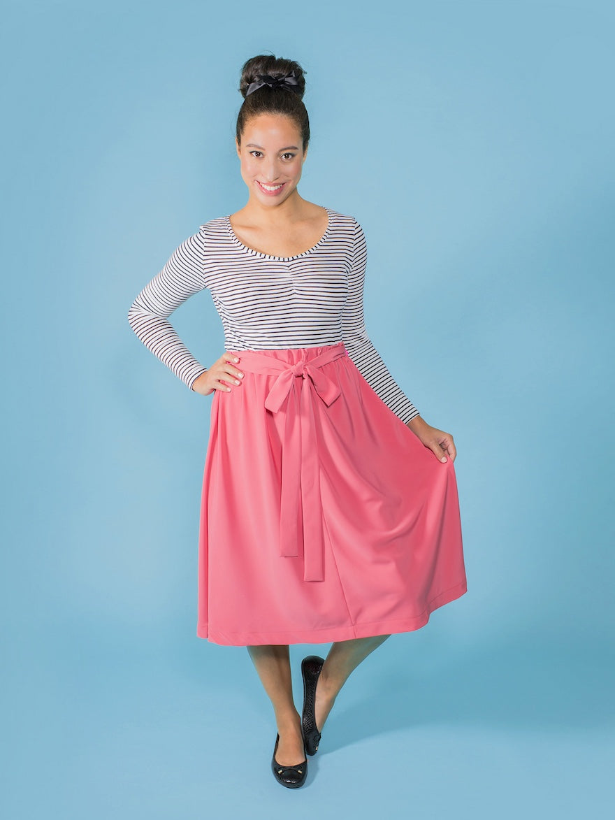 Woman wearing the Dominique Skirt sewing pattern from Tilly and the Buttons on The Fold Line. A skirt pattern made in cotton lawn, chambray, viscose (rayon), silk or polyester crêpe de chine fabric, featuring a flared silhouette, bias cut, midi length, be