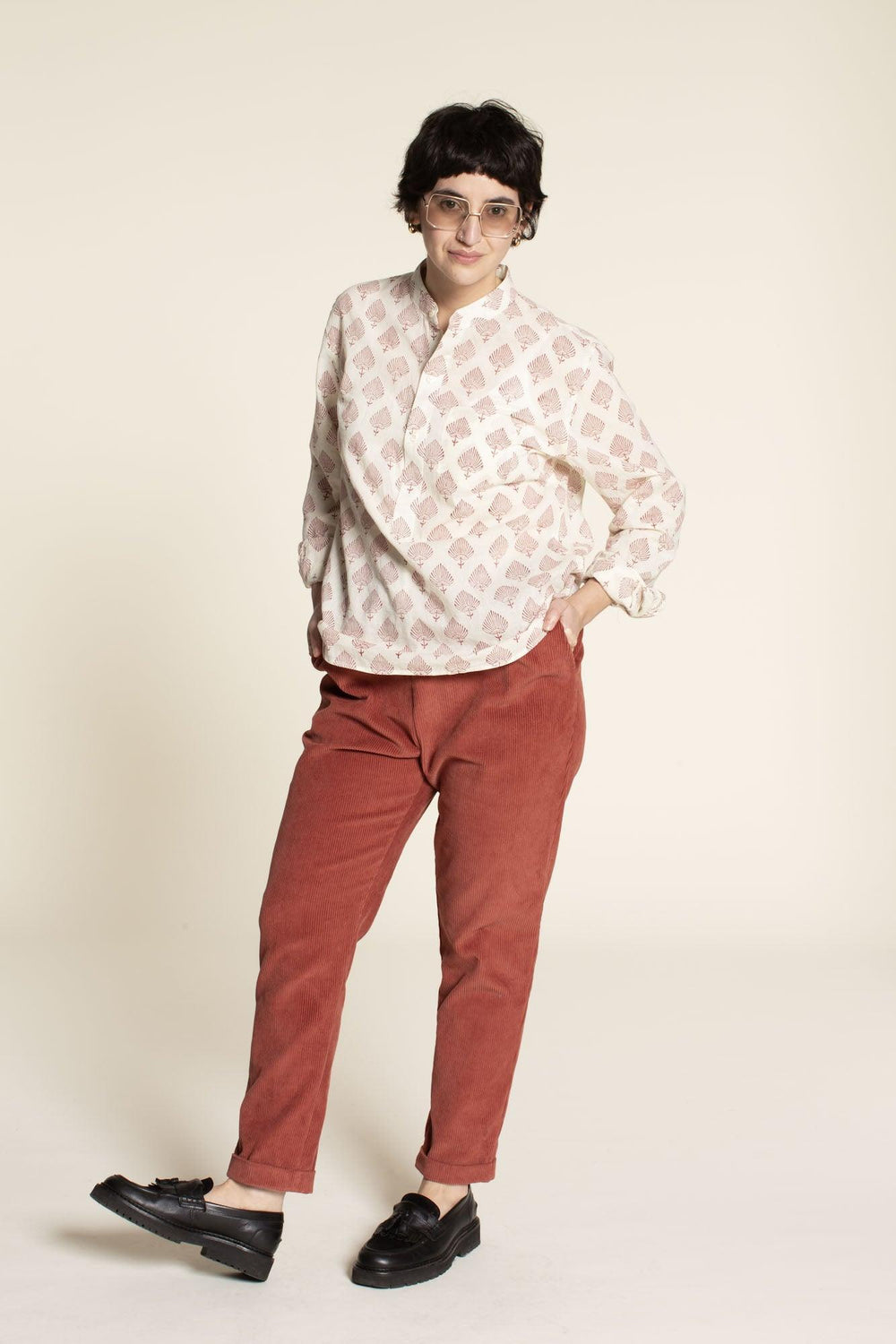 Woman wearing the Easy Pants sewing pattern from Wardrobe by Me on The Fold Line. A trouser pattern made in non-stretch cotton, linen, canvas or denim fabrics, featuring a relaxed fit, elastic waist, side pockets, back welt pockets, slim legs and cuffed h