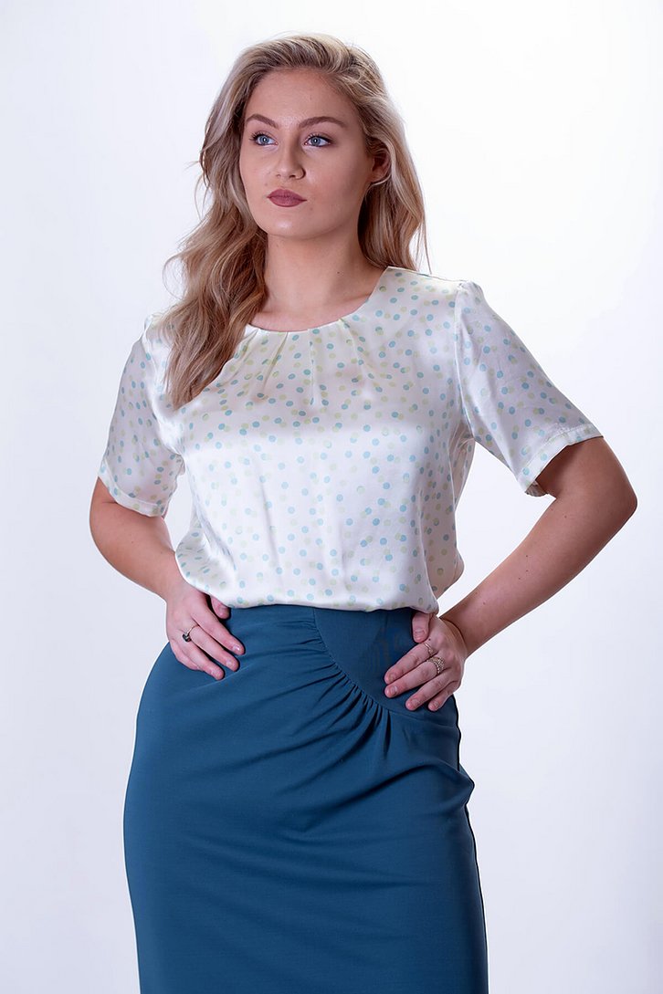 Women wearing the Eclipse Shell Blouse sewing pattern from The Pattern Cutters on The Fold Line. A top pattern made in polyester, viscose, lightweight cotton lawn or silk fabrics, featuring short sleeves, button and loop back neck opening and inverted ple