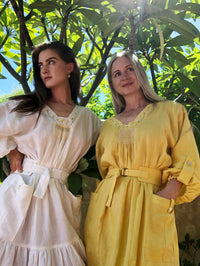 Women wearing the Edith Smock sewing pattern by Pattern Union. A dress pattern made in linen, voiles, satin, or velvet fabrics, featuring a smock style, belt, pockets with button tab detail, full sleeves with button tabs, V-neck and embroidery on the neck