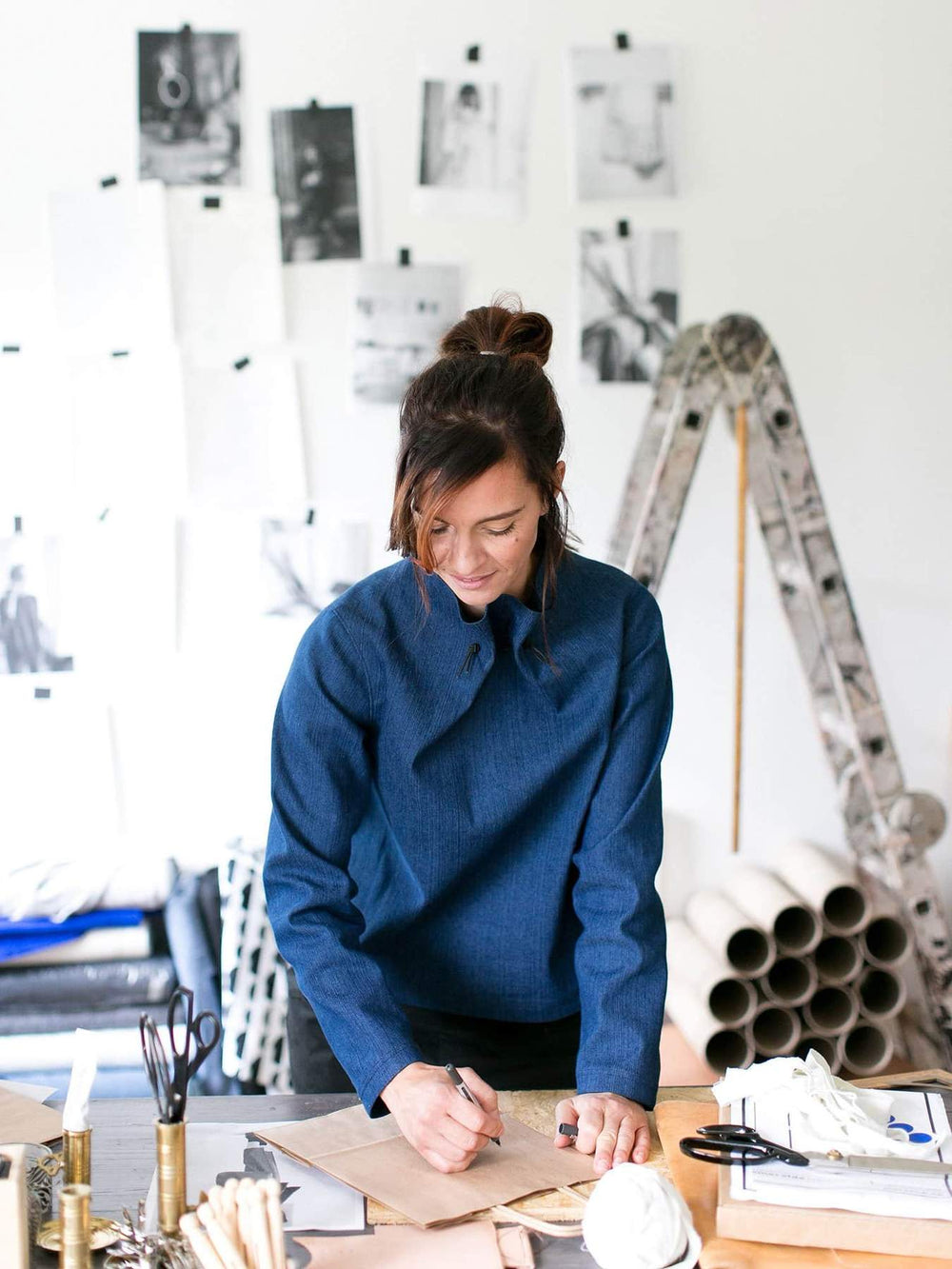 Woman wearing the Elastic Tie Sweater sewing pattern from The Assembly Line on The Fold Line. A top pattern made in cotton twill, denim or lightweight canvas fabrics, featuring a high neck tightened with an elastic drawstring, long sleeves and boxy silhou