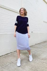 Woman wearing the Elemental Pencil Skirt sewing pattern from Sew House Seven on The Fold Line. A skirt pattern made in French terry, stretch sweatshirt fleece or cotton lycra fabrics, featuring a high waistband, elasticated waistband and below knee finish