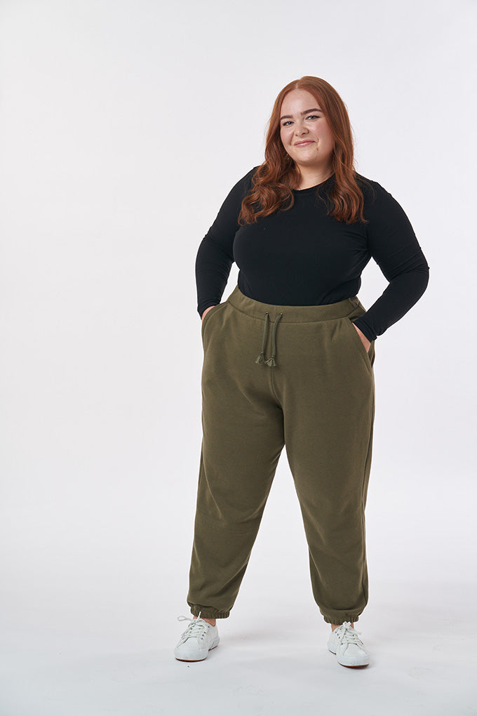 Woman wearing the Unisex Ellis Joggers sewing pattern from Sew Over It on The Fold Line. A unisex joggers pattern made in cotton sweatshirting, cotton fleece, polar fleece, french terry, ponte di roma and double knit fabrics, featuring an elasticated wais