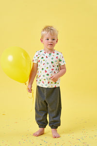 Child wearing the Baby/Child Elm T-shirt sewing pattern from Poppy & Jazz on The Fold Line. A T-shirt pattern made in cotton jersey or viscose jersey fabrics, featuring short sleeves and a round neck with optional press stud opening.