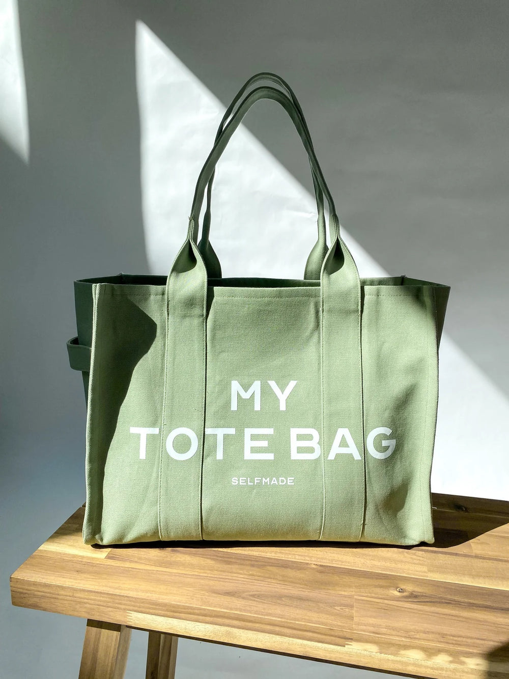 Photo showing the Emma Tote Bag sewing pattern from Bara Studio on The Fold Line. A bag pattern made in cotton canvas, sailcloth, jacquard or upholstery fabrics, featuring a zip closure, 2 inside pockets, reinforced carry handles, inside keyring loop, and
