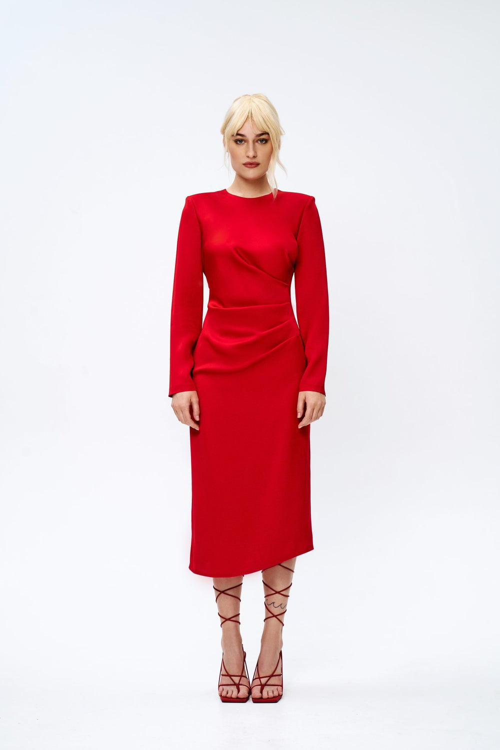 Woman wearing the Emory Dress sewing pattern from Vikisews on The Fold Line. A lined dress pattern made in dress-weight wool with elastane, gabardine cotton, dress-weight stretch denim, heavy or mid weight double knits, or stretch velour fabrics, featurin