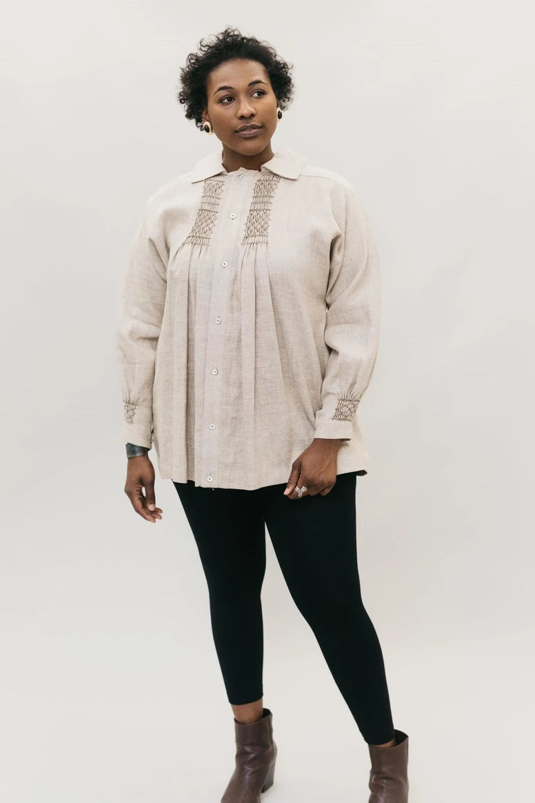 Woman wearing the 221 Adult/Child English Smock sewing pattern from Folkwear on The Fold Line. A smock top pattern made in cotton, rayon, wool, challis, broadcloth, corduroy or flannel fabrics, featuring a button-front opening, tunic length, flat collar, 