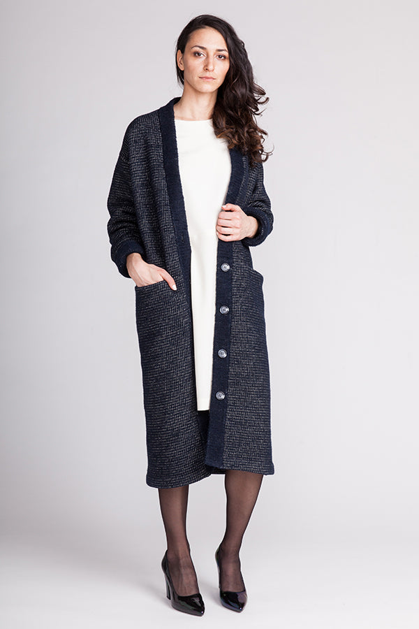 Woman wearing the Esme Maxi Cardigan sewing pattern from Named on The Fold Line. A cardigan pattern made in terry, sweatshirt jersey, heavier teddy or cable knit fabrics, featuring an oversized fit, chunky button closure, large in-seam front pockets, drop