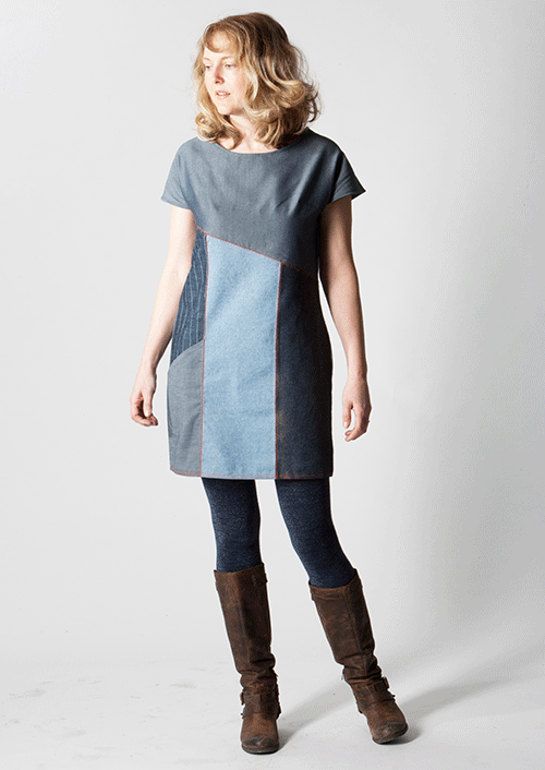 Woman wearing the Essential Denim Dress sewing pattern from Sew Different on The Fold Line. A shift dress pattern made in denim, heavy cotton, scuba or linen fabrics, featuring cap sleeves, round neck, diagonal bust line, diagonal pocket and above knee le