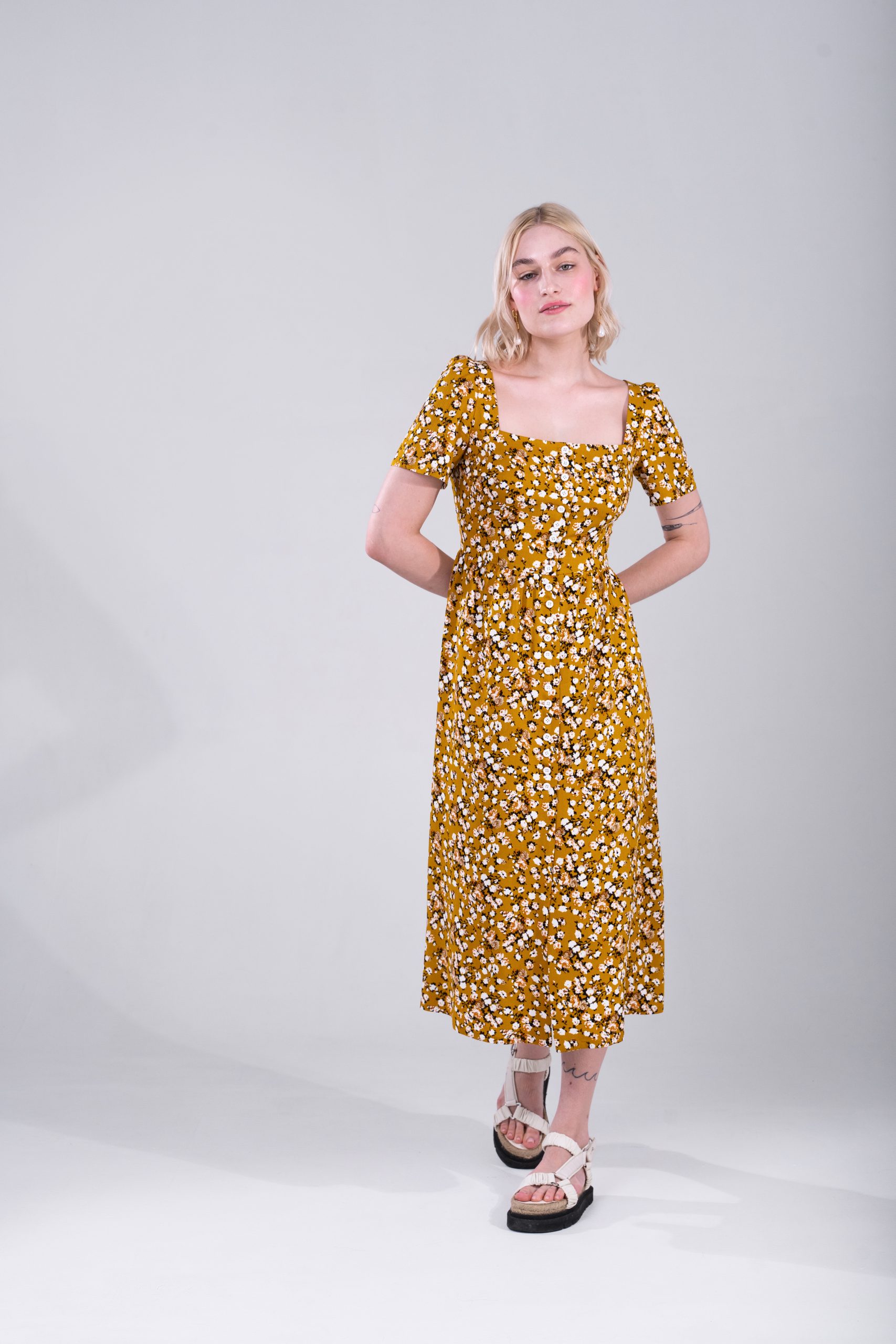 Woman wearing the Esther Dress sewing pattern from Vikisews on The Fold Line. A dress pattern made in viscose, crepe satin, challis, tencel, linen, cotton or cotton eyelet fabrics, featuring a close-fit, bust darts, waist darts on front and back bodice, s