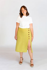 Woman wearing the Evelyn Skirt sewing pattern from Chalk and Notch on The Fold Line. A skirt pattern made in rayon’s, cotton lawn, cotton voile, linen, denim or flannel fabrics, featuring a high-waist, fitted through the waist, high slit, side-front butto