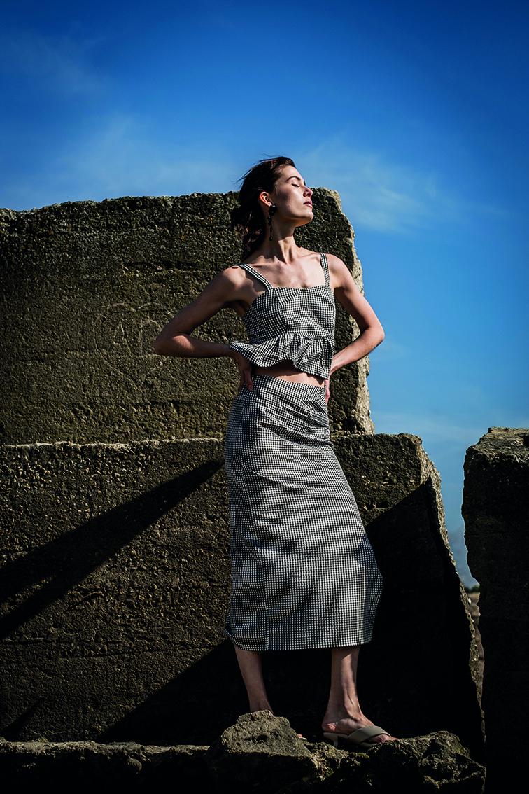 Women wearing the Ezra Skirt sewing pattern from Fibre Mood on The Fold Line. A pencil skirt pattern made in seersucker, chambray, linen, or lyocell fabrics, featuring a fitted silhouette, high-waist, high front slit, invisible side seam zip and midi leng