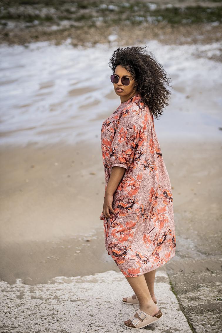 Women wearing the Edda Dress sewing pattern from Fibre Mood on The Fold Line. A dress pattern made in gauze, poplin, or lightweight cotton fabrics, featuring an oversized silhouette, jewel neck, dropped shoulders, balloon sleeves, side seam pockets and sh