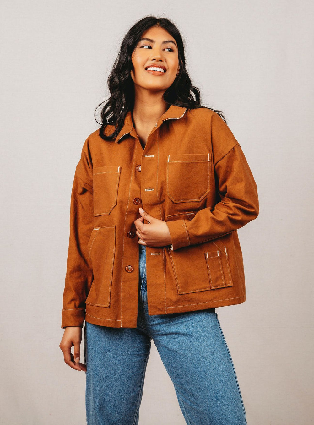 Woman wearing the Unisex Ilford Jacket sewing pattern from Friday Pattern Company on The Fold Line. A jacket pattern made in light to heavyweight woven fabrics, featuring drop shoulders, placket sleeve with cuff, patch pockets, button front closure and hi