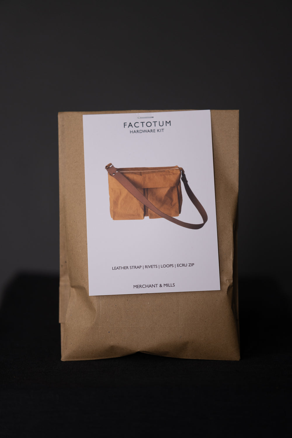 Photo showing the Factotum Bag from Merchant & Mills on The Fold Line. The kit includes hardware for the bag; 2 x 1″ loops, 4 x 9 mm rivets, 1 x 30 cm ecru and nickel zip, 1 x 1″ split cowhide leather strap. The metal finish is in Nickel.