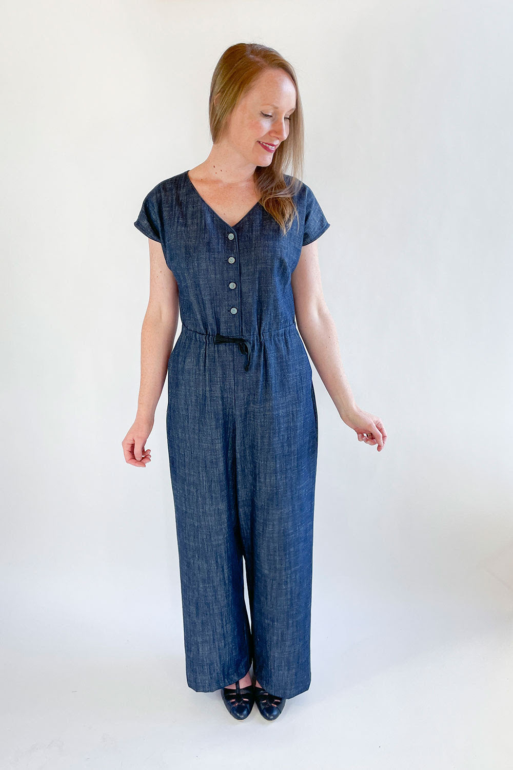 Woman wearing the Farris Jumpsuit sewing pattern from Jennifer Lauren Handmade on The Fold Line. A jumpsuit pattern made in rayon, silks, crepes, cotton lawn, linen, chambray, denim or pinwale corduroy fabrics, featuring grown-on sleeves, V neckline, angl