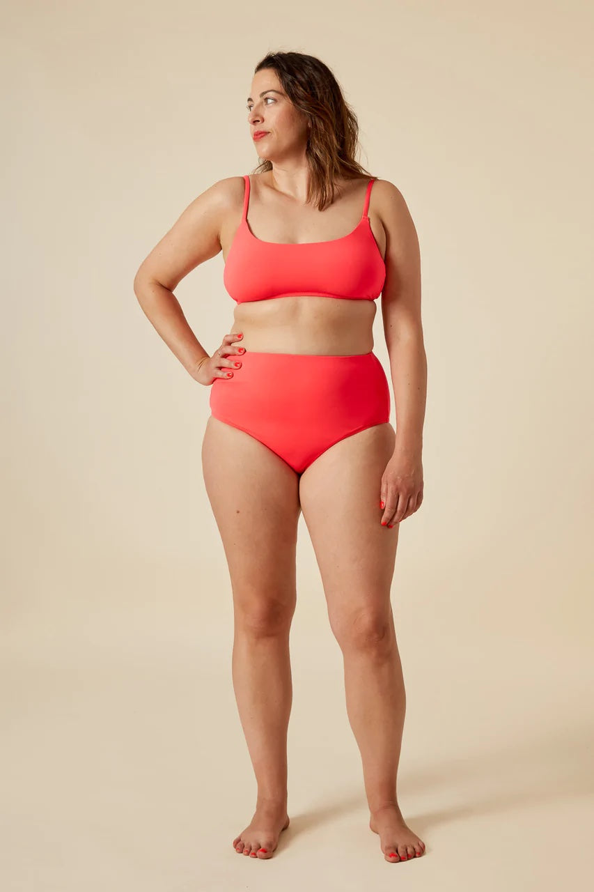 Woman wearing the Faye Swimsuit sewing pattern from Closet Core Patterns on The Fold Line. A bikini pattern made in swimsuit lycra with 4-way stretch fabrics, featuring a scoop neckline, narrow shoulder straps, full back coverage, high rise waist and medi
