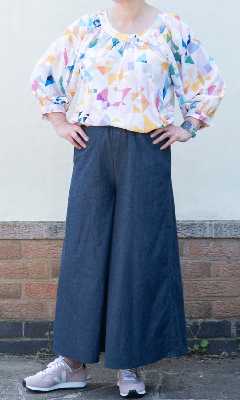 Woman wearing the Fern Culottes sewing pattern from Bobbins and Buttons on The Fold Line. A culottes pattern made in linen, lightweight denim, medium weight cotton, Tencel twill, viscose or ponte roma fabrics, featuring wide legs, elasticated waist, and s