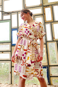 Woman wearing the Florence Wrap Dress sewing pattern from Atelier Jupe on The Fold Line. A wrap dress pattern made in viscose, cotton, tencel, linen, double-gauze fabrics, featuring a loose-fit, midi-length, self-fabric belt, V-neck, collar with lapel, dr