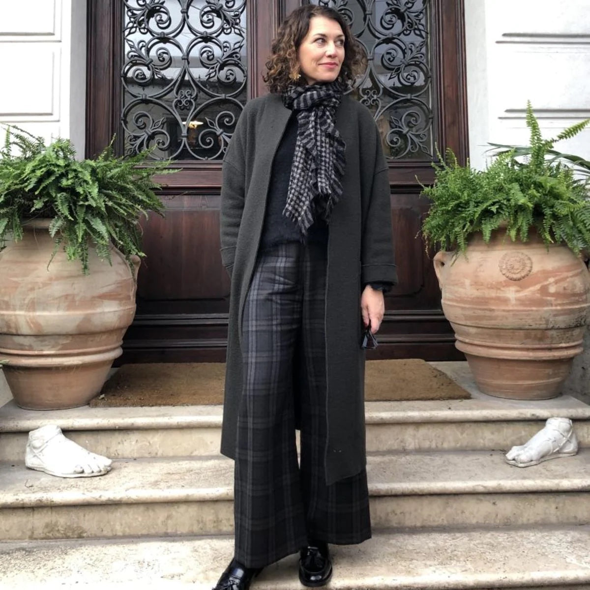 Woman wearing the Florence Coat sewing pattern from Tessuti Fabrics on The Fold Line. A coat pattern made in boiled or felted wool fabrics, featuring a longline, oversized, unlined, collarless neckline, dropped shoulders, patch pockets, full-length sleeve