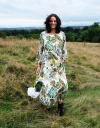 Woman wearing the Folia Frock sewing pattern from Sew Different on The Fold Line. A dress pattern made in cotton, linen, viscose, denim, needlecord, wool or jersey fabrics, featuring a midi length, gentle ballooning hemline, french darts, large patch pock