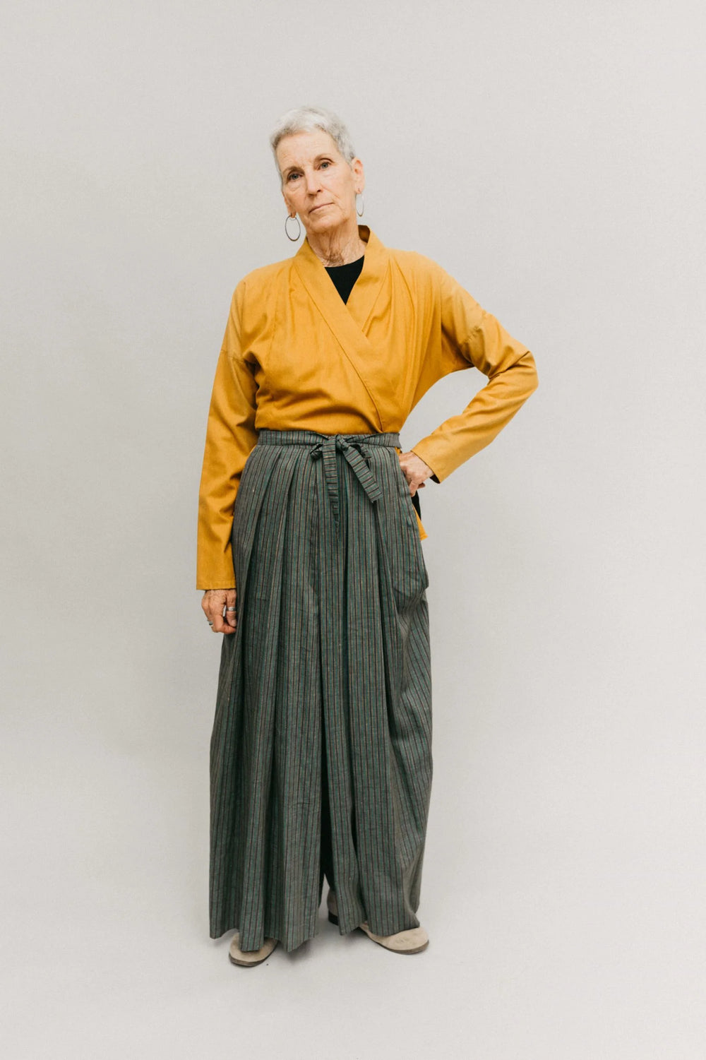 Woman wearing the 151 Japanese Hakama and Kataginu sewing pattern from Folkwear on The Fold Line. A pleated front vest and pleated trousers/skirt pattern made in cottons, linens, linen blends, ramie, hemp, silks, satin or taffeta fabrics, featuring a loos