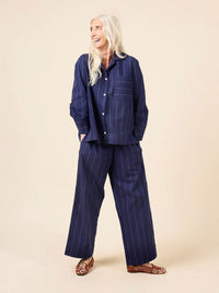 Woman wearing the Fran Pajamas sewing pattern from Closet Core Patterns on The Fold Line. A pyjama pattern made in broadcloth, voile, poplin, chambray, cotton flannel, linen, silk crepe de chine, satin, rayon challis or viscose fabrics, featuring a relaxe