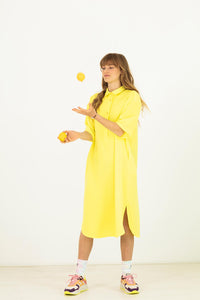 Woman wearing the Franca Dress sewing pattern from Fibre Mood on The Fold Line. A shirt dress pattern made in viscose (crepe), polyester (crepe), cotton, satin, linen or Tencel fabrics, featuring a mid-length hem, curved side slits, polo collar, back yoke