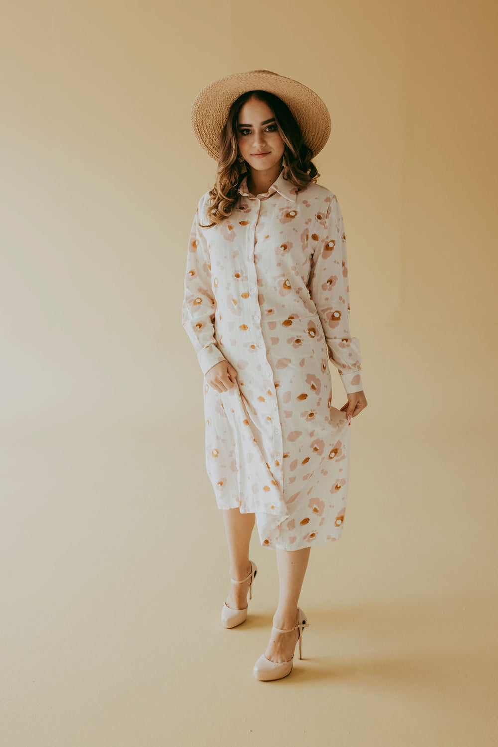 Woman wearing the Frances Shirt Dress sewing pattern from Pattern Sewciety on The Fold Line. A shirt dress pattern made in cotton, cotton blends, linen, linen blends, chambray or silk fabrics, featuring a two-piece collar, button front, cuffed sleeves, wa