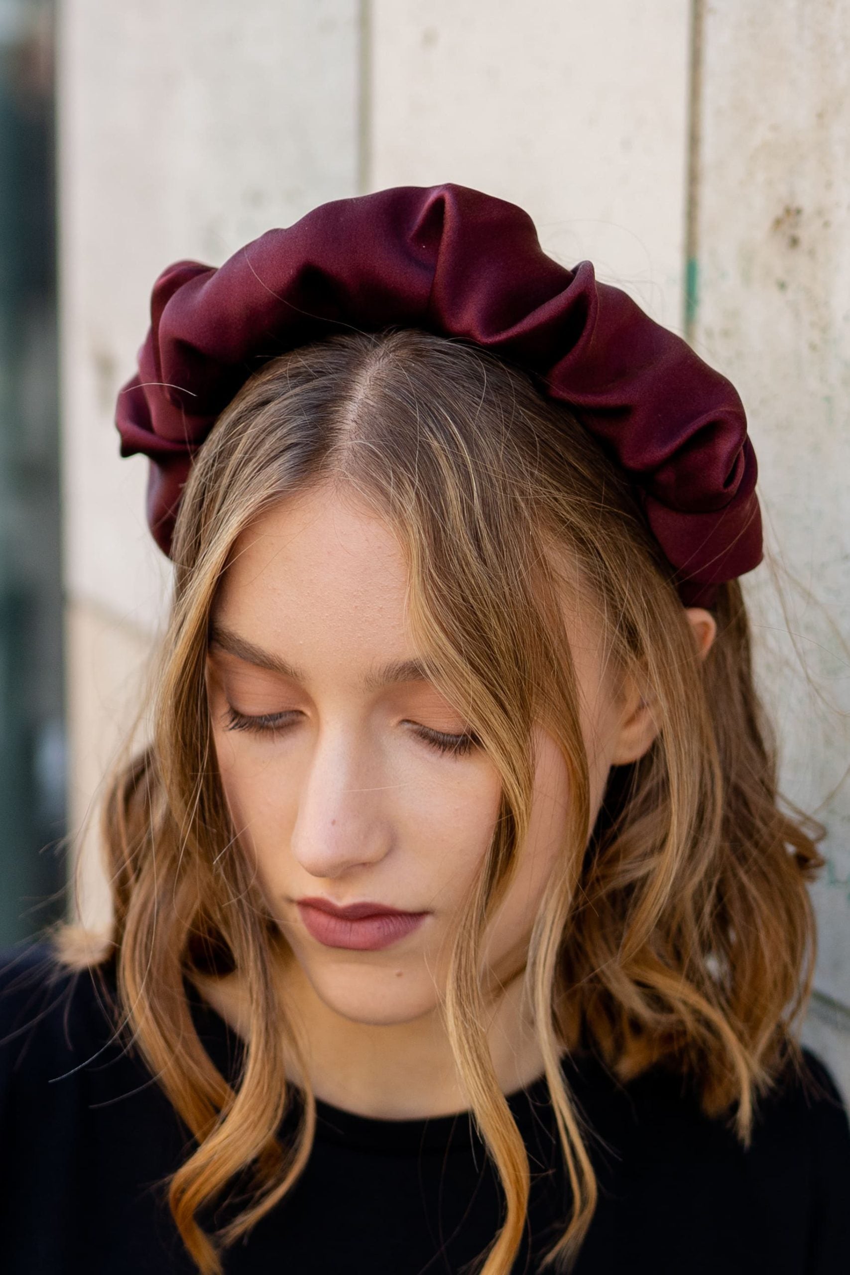 Woman wearing the Frances Headband sewing pattern from JULIANA MARTEJEVS on The Fold Line. A headband pattern made in silk fabrics, featuring foam attached to a headband base then covered in gathered silk fabric.