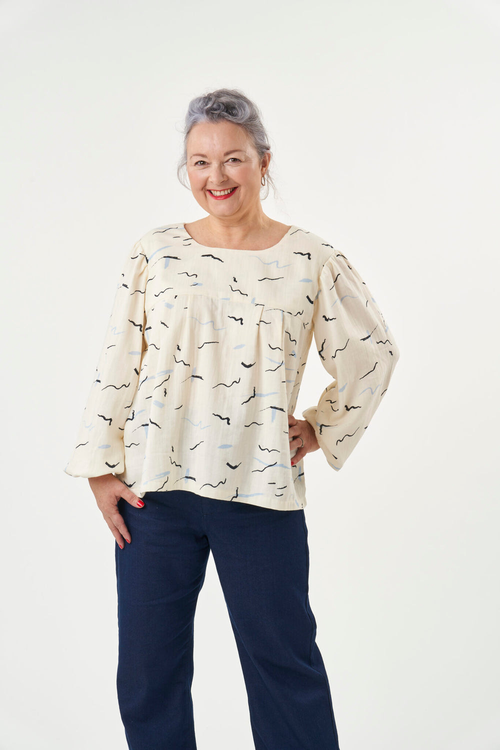Woman wearing the Frida Blouse sewing pattern from Sew Over It on The Fold Line. A blouse pattern made in rayon/viscose, double gauze, broderie anglaise, crepe, Tencel, voile, lawn or Swiss dot fabrics, featuring a front and back yoke with pleats on both 