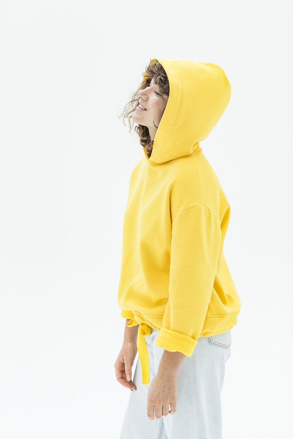 Women wearing the Frikka Hoodie sewing pattern from Fibre Mood on The Fold Line. A hoodie pattern made in sweatshirting fabrics like interlock jersey, neoprene and stretch with “weight”, featuring a roomy hood, oversized silhouette, long sleeves and waist