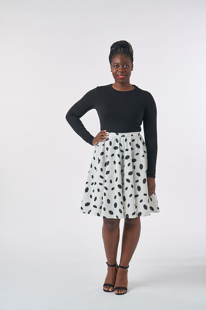 Woman wearing the Full Circle Skirt sewing pattern from Sew Over It on The Fold Line. A circle skirt pattern made in cottons, broderie anglaise, jacquards, lightweight wools, suiting fabrics or medium weight crepe fabrics, featuring zip closure, waistband