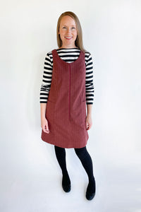 Woman wearing the Georgie Pinafore sewing pattern from Jennifer Lauren Handmade on The Fold Line. A pinafore pattern made in denim, corduroy, wool, cotton ticking or poplin/broadcloth fabrics, featuring a semi-fit, V neckline, exposed centre front zip, si