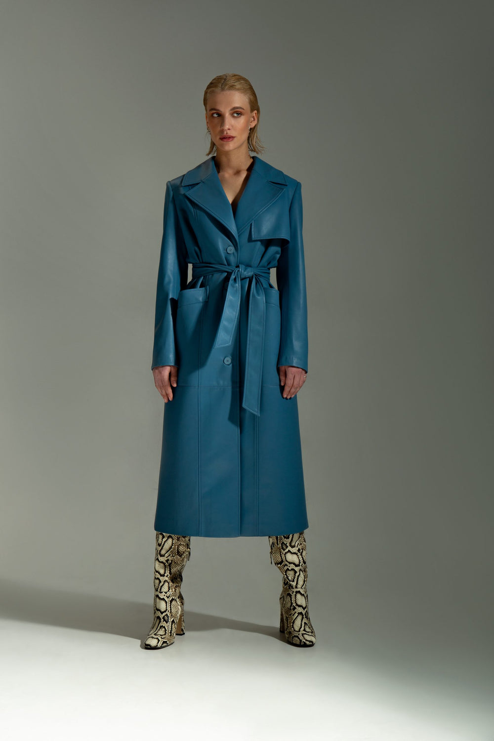 Woman wearing the Gladys Coat sewing pattern from Vikisews on The Fold Line. A coat pattern made in faux leather, denim, corduroy, blended raincoat fabrics or thick cotton gabardine fabrics, featuring a semi-fit, straight-cut, fully lined, detachable belt
