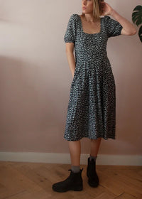 Woman wearing the Goldenrod Dress sewing pattern from French Navy on The Fold Line. A dress pattern made in viscose/rayon, rayon challis, lightweight linen, linen/rayon blends, chambray, or cotton fabrics, featuring a structured bodice, square neck, flare