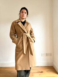 Woman wearing the Grace Coat sewing pattern from Bella loves Patterns on The Fold Line. A coat pattern made in wool, cashmere, boiled wool, Melton, or double face wool fabrics, featuring a mid-calf length, double-breasted, straight silhouette, dolman slee