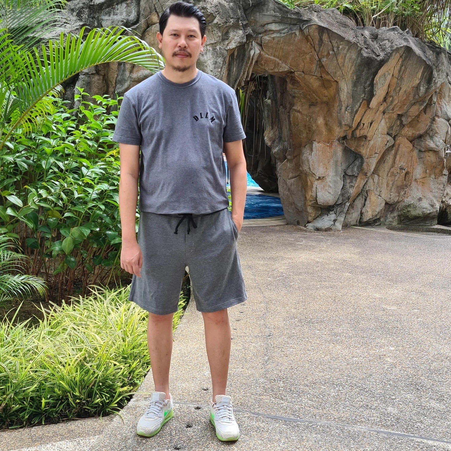 Man wearing the Men's Gym Shorts sewing pattern from Wardrobe by Me on The Fold Line. A shorts pattern made in Jersey, sweatshirt fabric or lightweight woven fabrics, featuring an elastic and drawstring waist, side and back pockets, decorative fly and jus