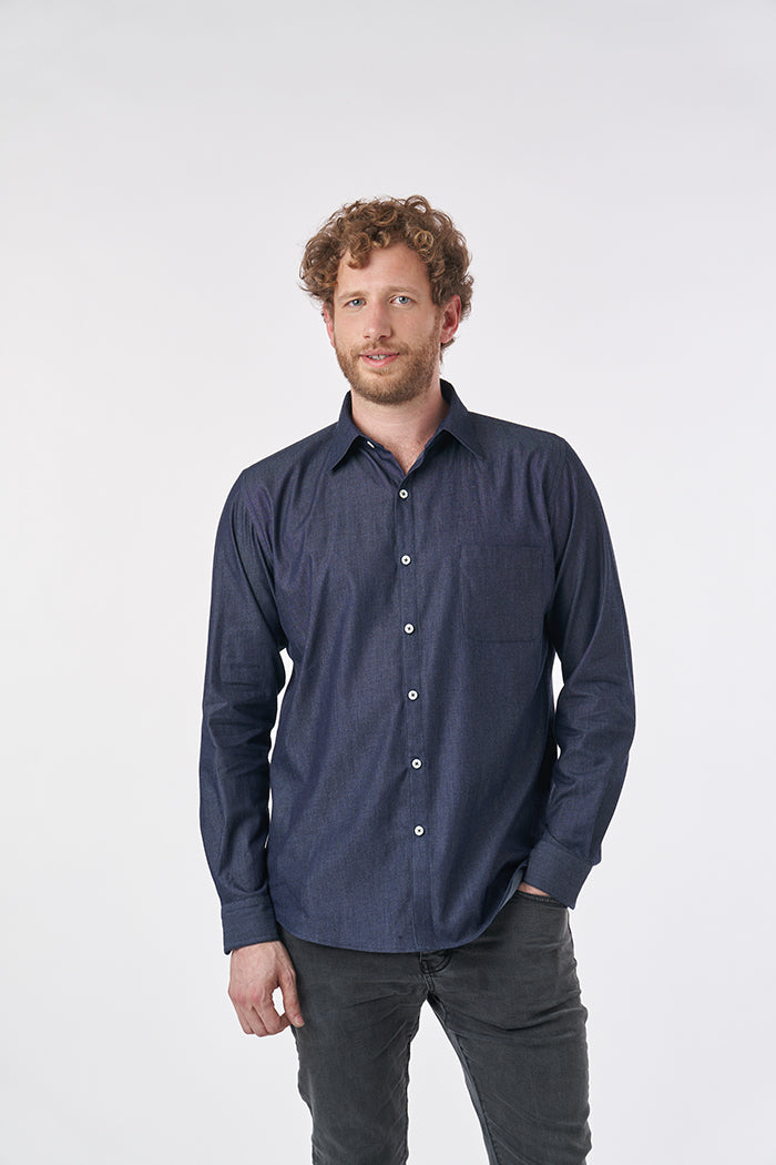 Man wearing the Hackney Shirt sewing pattern from Sew Over It on The Fold Line. A shirt pattern made in lawn, poplin, flannel, chambray, needlecord and shirting fabrics, featuring a collar with collar stand, back yoke with box pleat, traditional shirt cuf