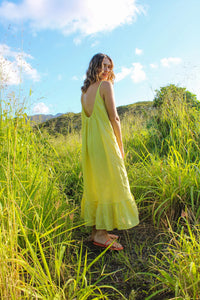 Woman wearing the Hallon Dress sewing pattern from Paradise Patterns on The Fold Line. A sundress pattern made in silk crepe, charmeuse, rayon twill, challis, tencel, cotton or linen fabrics, featuring a very relaxed fit, ruffled hem, very low back with g