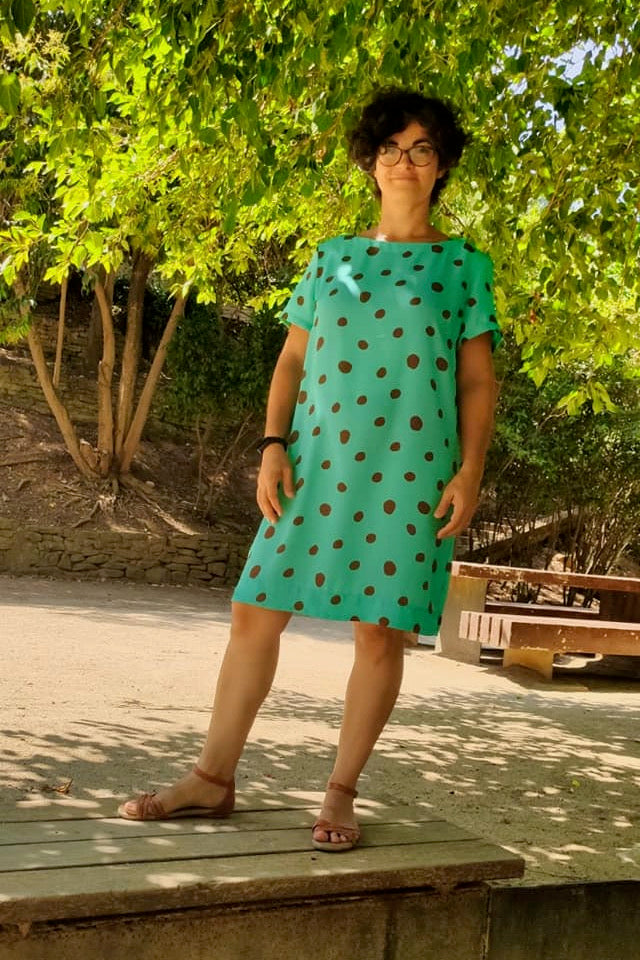 Woman wearing the Hannah Dress pattern from Pattern Sewciety on The Fold Line. A dress pattern made in cotton, cotton blends, linen, linen blends, rayon, satin, chambray or silk fabrics, featuring short sleeves, bust darts, knee length finish, boxy silhou