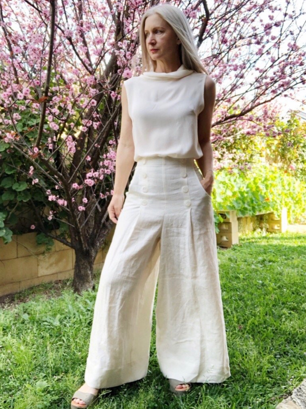Woman wearing the Hannah Culottes sewing pattern from Pattern Union on The Fold Line. A culottes pattern made in linen, Tencel, crepe, rayon, tweed, wool, or canvas fabrics, featuring a full length wide-leg, self-faced high waist with button detail on fro