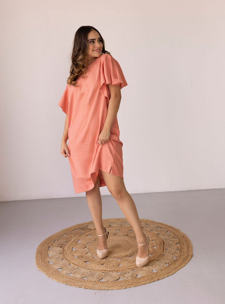 Woman wearing the Hannah Dress sewing pattern from Pattern Sewciety on The Fold Line. A dress pattern made in cotton, cotton blends, linen, linen blends, rayon, satin, chambray or silk fabrics, featuring a shift style silhouette, flounce sleeve, bust dart