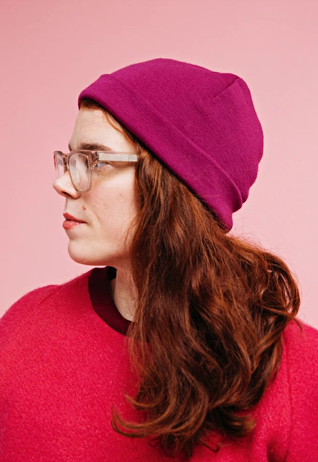 Woman wearing the Harald Beanie sewing pattern from Melilot on The Fold Line. A hat pattern made in jersey fabrics, featuring a pull on hat with folded hem.