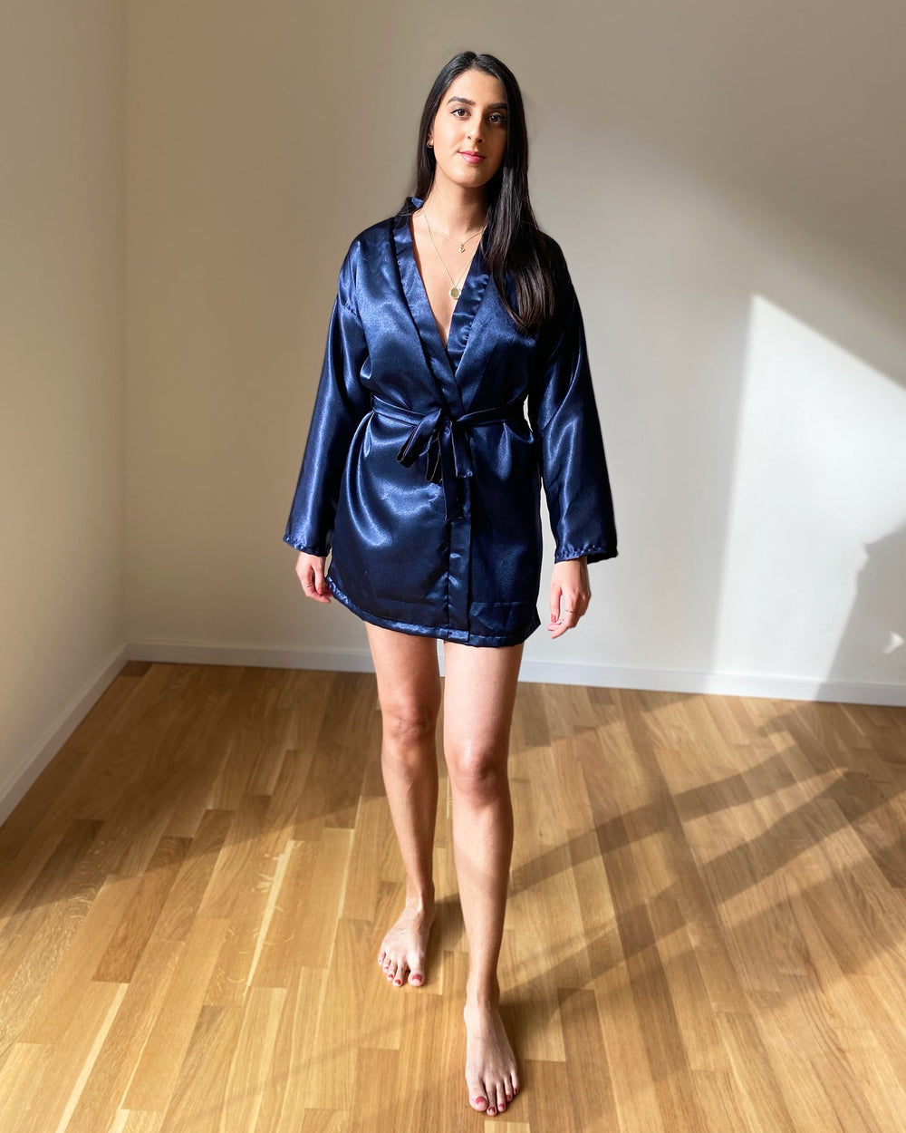 Woman wearing the Hayley Robe sewing pattern from Tammy Handmade on The Fold Line. A robe pattern made in cotton, linen, viscose, satin or silk fabrics, featuring a loose-fitting silhouette, detachable belt, belt loops, dropped shoulders, full-length slee