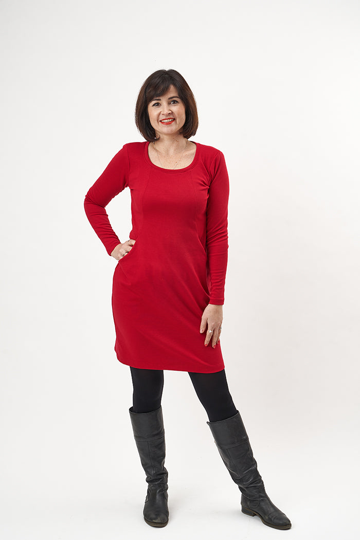 Woman wearing the Heather Dress sewing pattern from Sew Over It on The Fold Line. A knit dress pattern made in ponte di roma, double knits or interlock knit fabrics, featuring in-seam pockets, panelled bodice, full length sleeves, scoop neckline and above