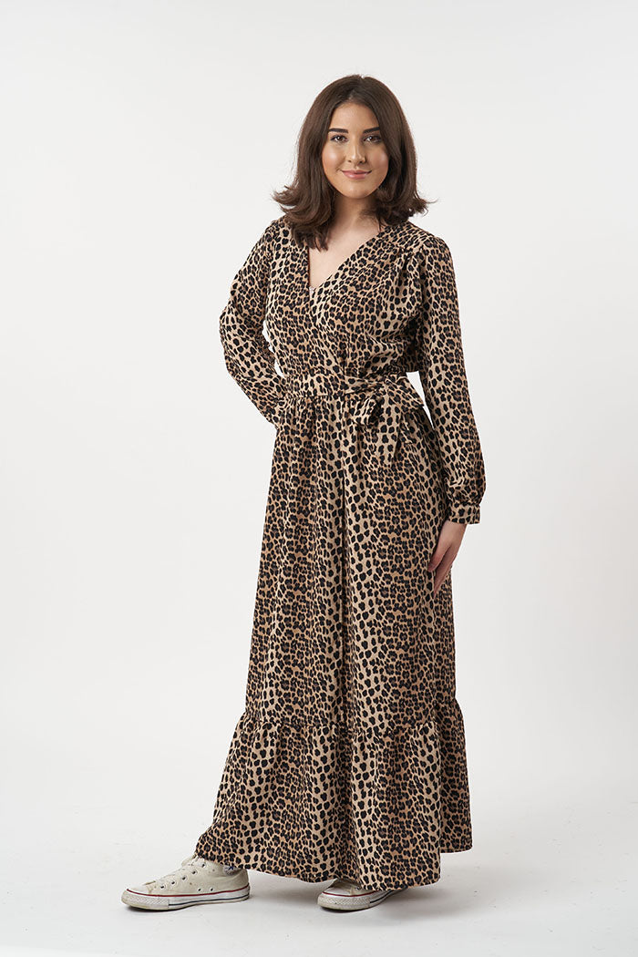 Woman wearing the Heidi Dress sewing pattern from Sew Over It on The Fold Line. A wrap dress pattern made in georgette, chiffon and rayon fabrics, featuring gathered bodice and skirt, waistband, loose full-length sleeves with closed cuffs, double-tie wais